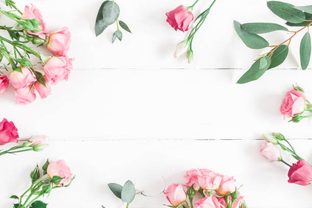 istock Eucalyptus branches and pink rose flowers. Flat lay, top view 930448000