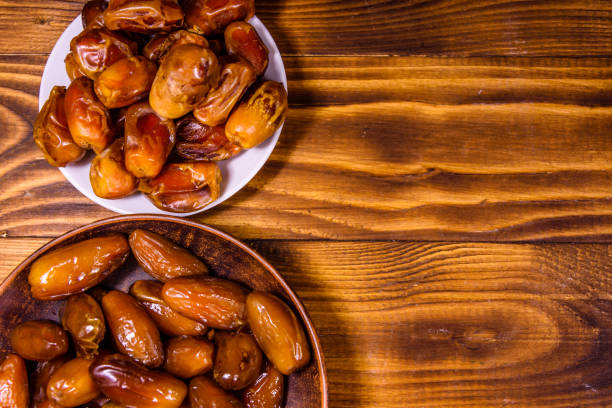 istock Date fruits on a wooden table. Top view 930448214