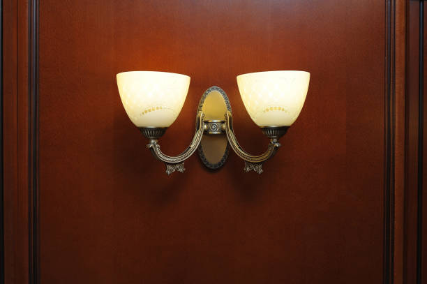istock Beautiful double lamp-sconces on a brown wall. 930448376