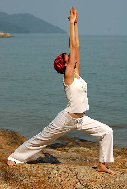 istock virabhadrasana, hatha yoga by the beach 93045734