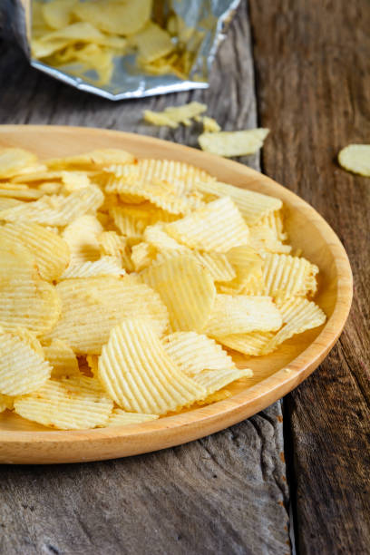 istock Snacks in a wooden dish on a table 930458098