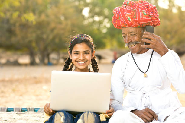 istock Rural girl with father talking on mobile phone 930459132