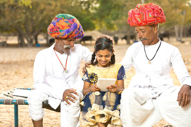 istock Rural Indian men with girl using digital tablet 930459250
