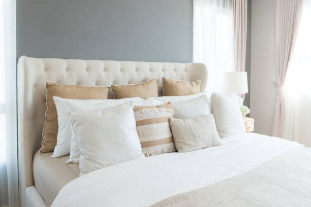 istock Bedroom in soft light colors. big comfortable double bed in elegant classic bedroom at home. 930461932
