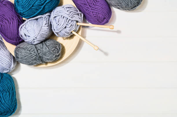 istock Knitting accessories top view on white wooden background 930462118
