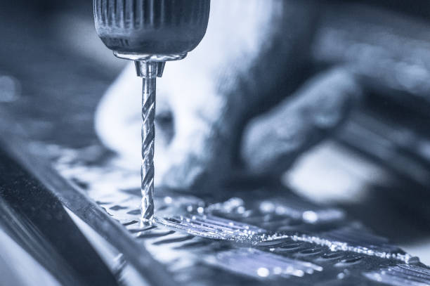 istock Drill screwdriver workflow creation of metal parts. male metal worker using drillpress. Toned image. 930464592