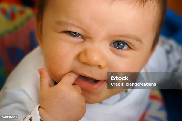 A Baby In Crib And Pajamas Teething On Finger Stock Photo - Download Image Now - Teething Toy, Baby - Human Age, Biting