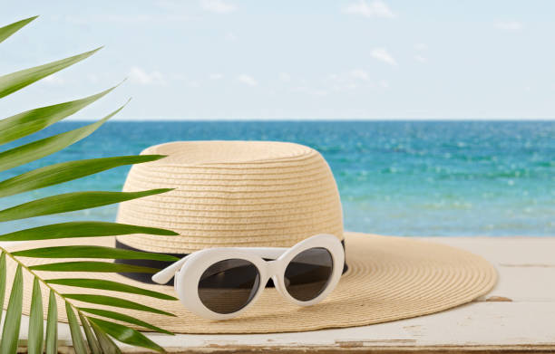 istock Summer seascape. Relax on the beach, hat and white sunglasses. 930472268
