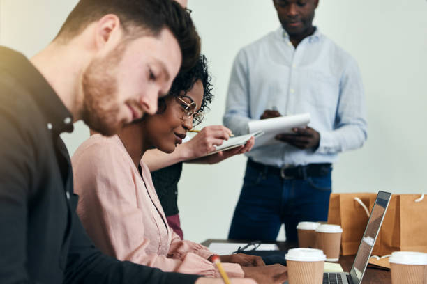istock Diverse business colleagues working at a table in an office 930475730