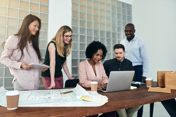 istock Smiling designers working together at a table in an office 930476080
