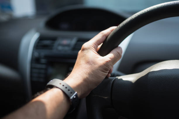 istock Car driver hands holding steering wheel.Car driver hands holding steering wheel. 930476174