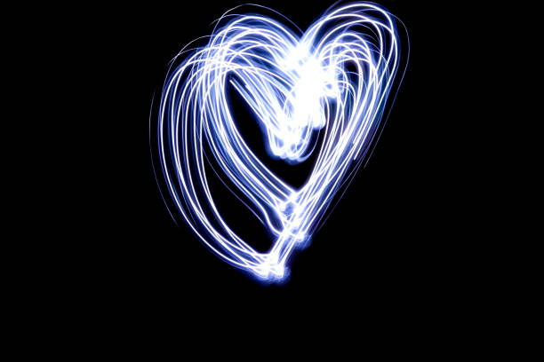 istock Heart line symbol created by light  black background 930476714