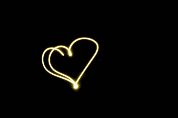 istock Heart line symbol created by light  black background 930476974