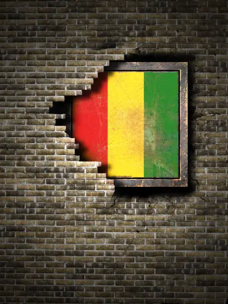 Photo of Old Guinea flag in brick wall