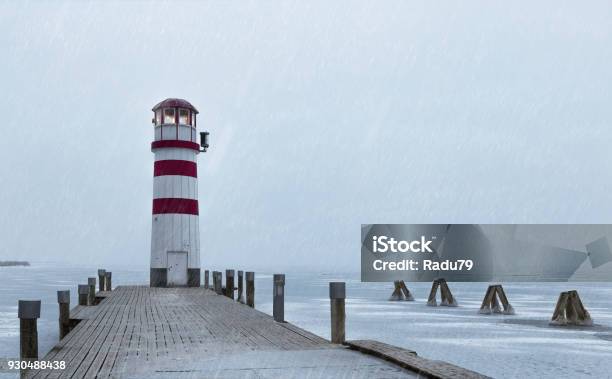 Lighthouse At Sunrise With Fog And Rain During Winter Stock Photo - Download Image Now