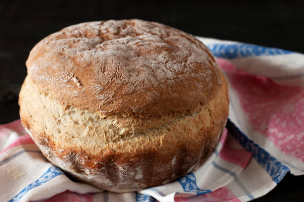 istock loaf of bread on wooden background, 930499090