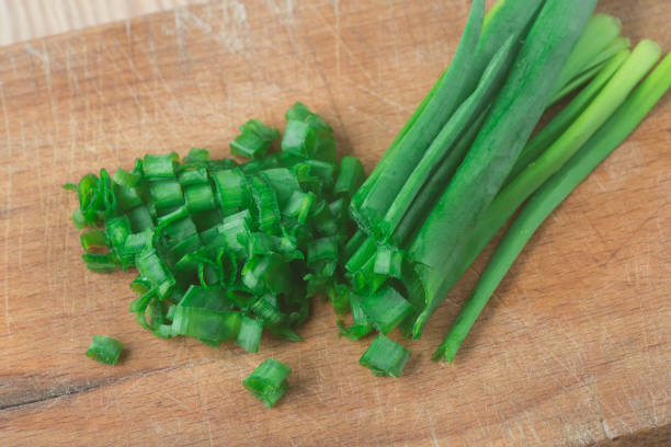istock fresh green onion chives on wooden board 930501410
