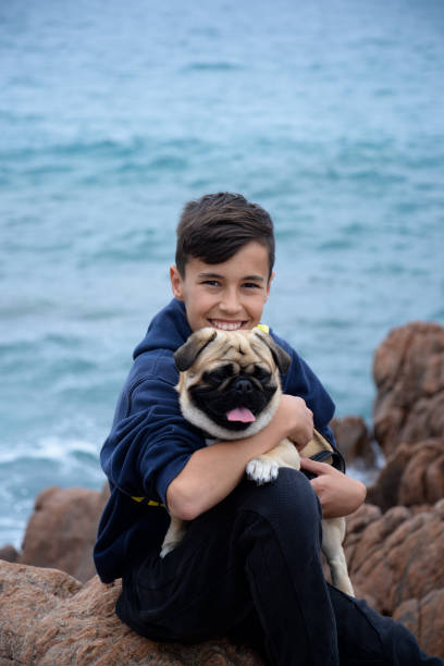 istock Smiled teenager with pug dog 930501572