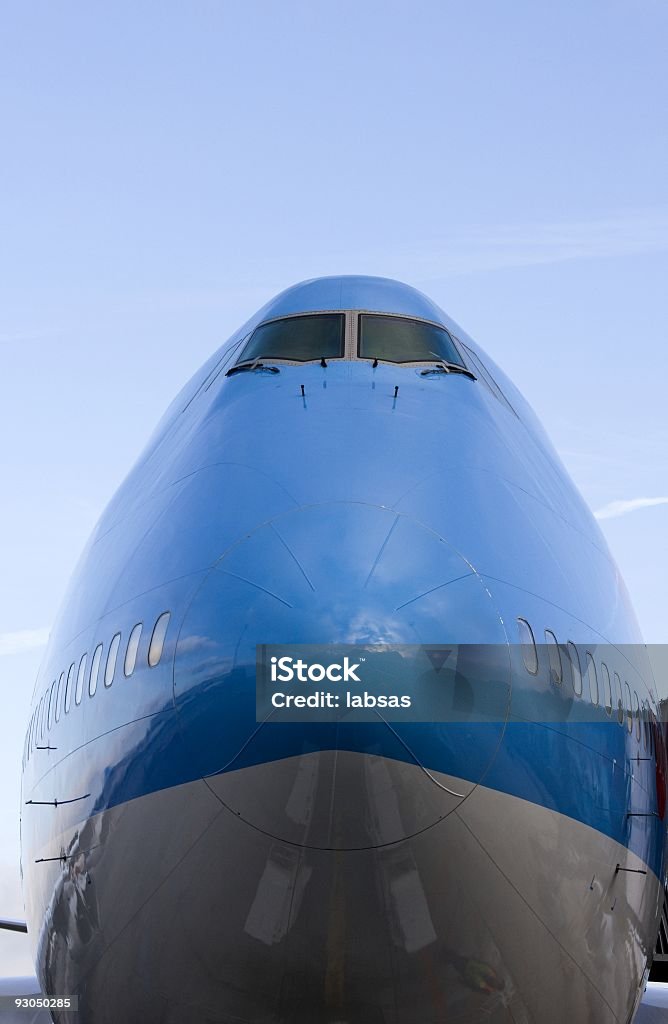 Jumbo jet docked at the gate. A 747 docked in an international airport, waiting to take off. Front View Stock Photo