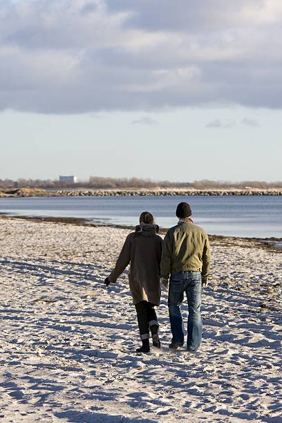istock Two young people walking on a cold november beach. 93050292