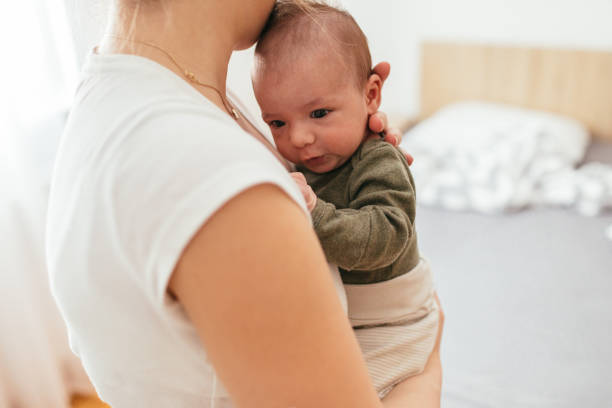 istock Mother holding her newborn baby 930504504