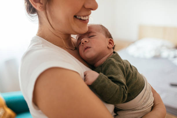 istock Mother putting her baby to sleep 930504912