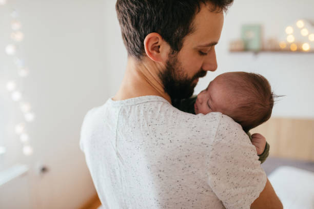 istock Father putting his baby to sleep 930505228