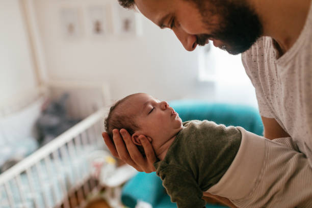 istock Father putting his baby to sleep 930505230