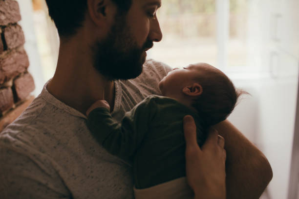 istock Father putting his baby to sleep 930505360
