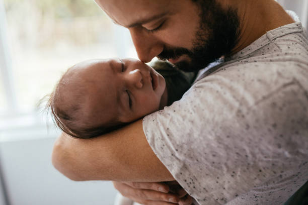 istock Father putting his baby to sleep 930505432