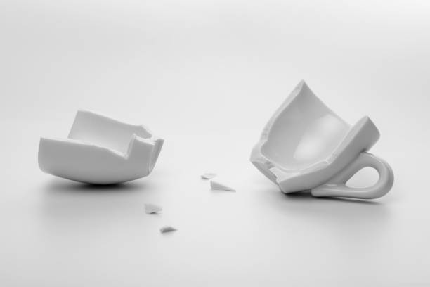 istock two halves of broken white cup with few little pieces, concept accident, mock up 930508384
