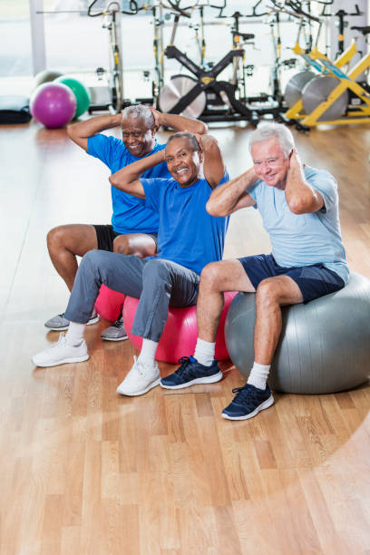 istock Three multi-ethnic senior men in gym exercising 930514896