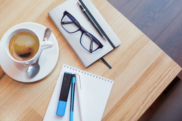 istock A cup of coffee on the table next to a notebook and pens 930515100