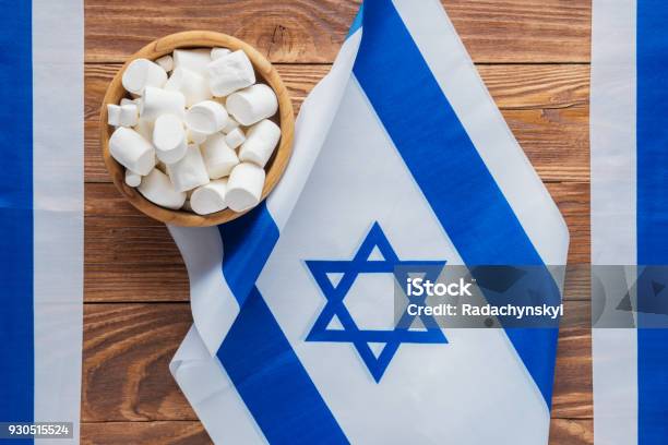 Israel National Flags And Marshmallows On A Wooden Background Top View Flat Lay Patriotic Holiday Concept Of Independence Day Israel Yom Haatzmaut Stock Photo - Download Image Now