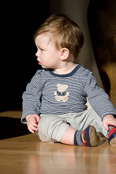 istock Baby Sitting on Hardwood Floor 93051621