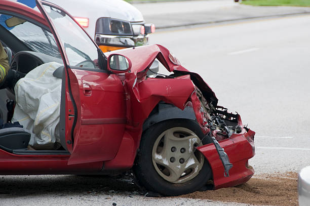 Red car with front crushed from vehicle accident stock photo