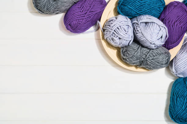 istock Knitting accessories top view on white wooden background 930517914