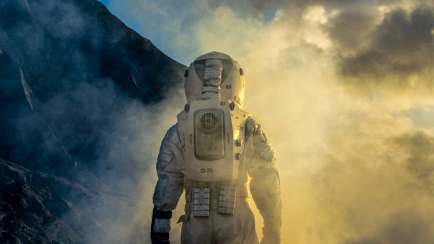 istock Courageous Astronaut in the Space Suit Explores Mysterious Alien Planet Covered in Mist. Adventure. Space Travel, Habitable World and Colonization Concept. 930523118