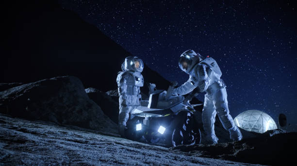 istock Two Astronauts in Space Suits on an Alien Planet Prepare Space Rover for Surface Exploration Mission. Futuristic Concept about Space Colonization. 930523170
