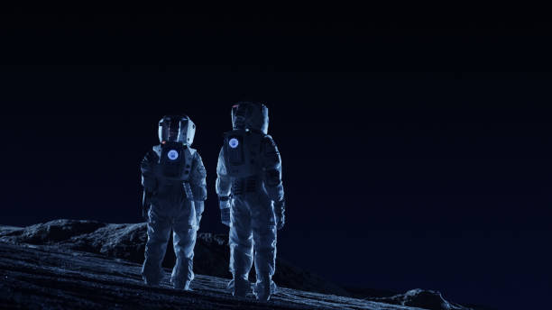 istock Two Astronauts in Space Suits Stand on the Alien Planets Observing Extraterrestrial Terrain. Space Travel and Extraterrestrial Colonization Concept. 930523198