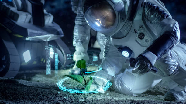istock Two Astronauts Analyzing Plant Life Found on Alien Planet. Infographics Show Data about Oxygen Generation, DNA and Molecular Structure. Technological Advance and Space Exploration. 930523314