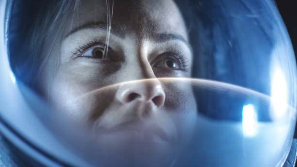 Portrait Shot of the Courageous Female Astronaut  Wearing Helmet in Space, Looking around in Wonder. Space Travel, Exploration and Solar System Colonization Concept. Portrait Shot of the Courageous Female Astronaut  Wearing Helmet in Space, Looking around in Wonder. Space Travel, Exploration and Solar System Colonization Concept. spacewalk photos stock pictures, royalty-free photos & images