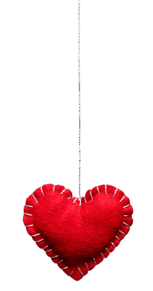 Crocheted amigurumi pink red heart on a white background. Valentine's day banner with a copyspace