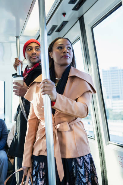 istock African-American man and woman riding train 930526464