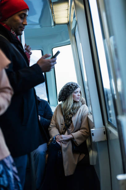 istock Young woman sitting in train looking out window 930526672