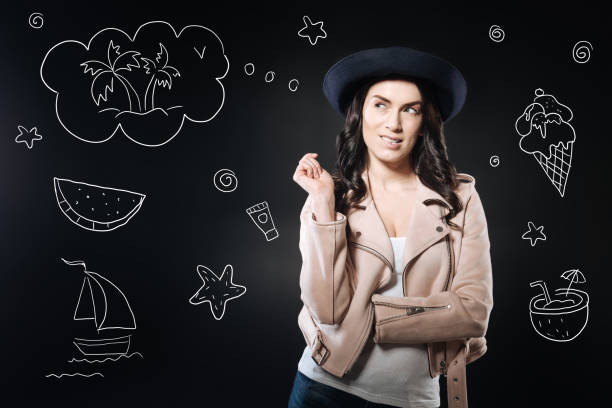 istock Beautiful woman biting her lip while dreaming of holidays 930527676