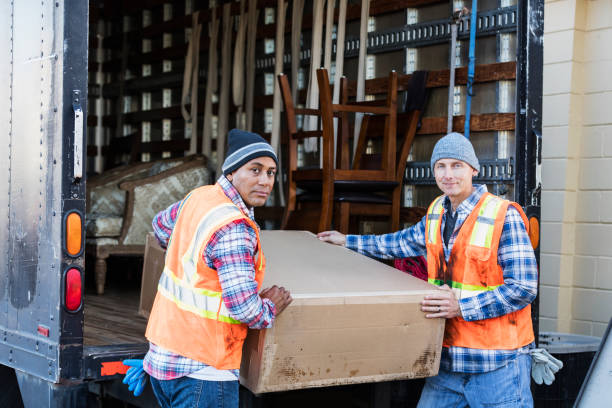istock Two workers with a truck, moving large box 930529746
