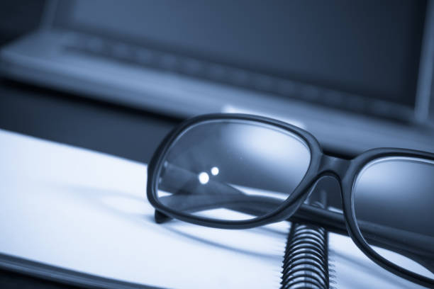 istock Black framed glasses on the computer keyboard with a very shallow depth of field 930530856