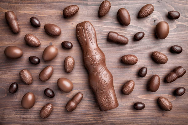 istock Chocolate Easter bunny and eggs on wooden background 930536386