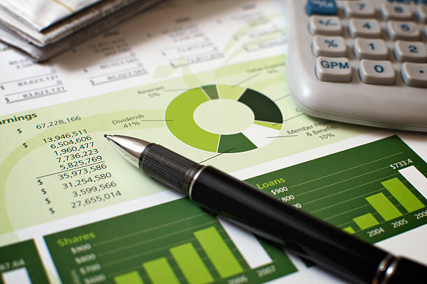 Black pen with financial figures and calculator